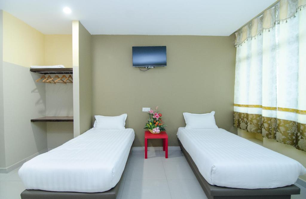 Postel nebo postele na pokoji v ubytování Hotel Raja Bot
