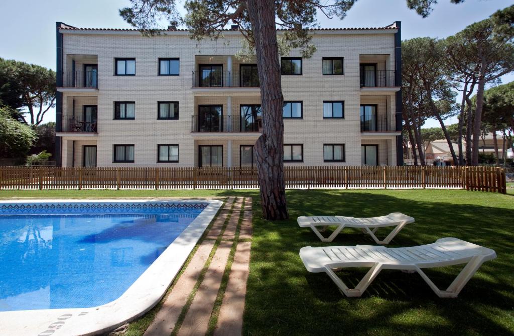 a building with a swimming pool in front of a building at SG Marina 54 Apartments in Castelldefels