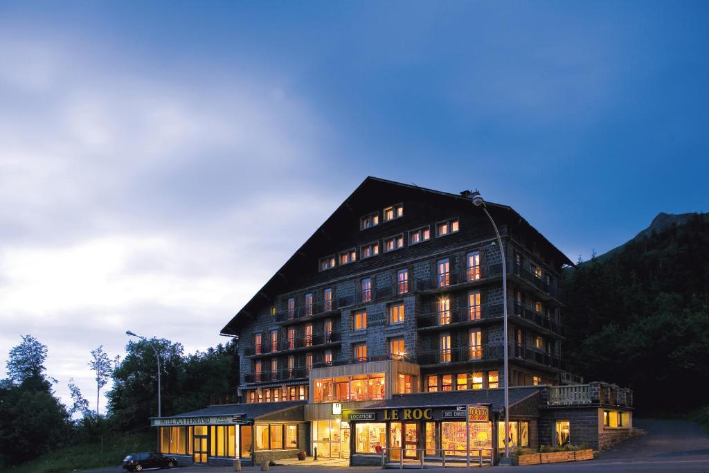 a large building with a lot of windows at Logis Du Puy Ferrand in Le Mont-Dore