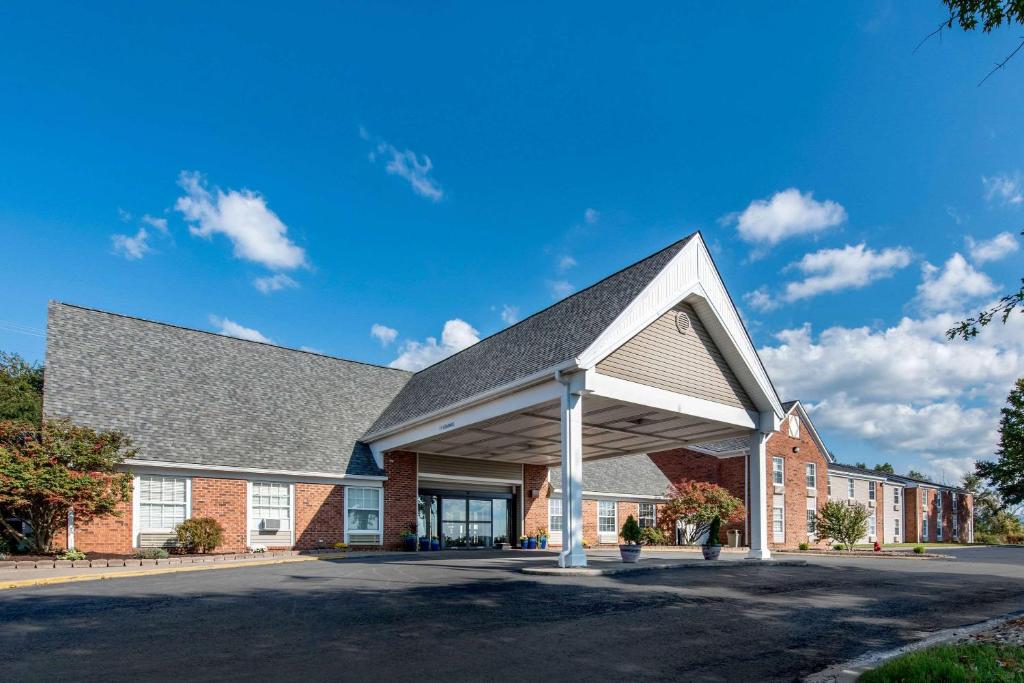 a large brick building with a gray roof at Quality Inn in Morgantown