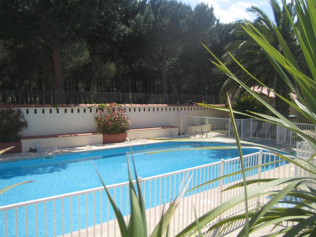 een zwembad naast een wit hek bij Plage des Pins in Argelès-sur-Mer