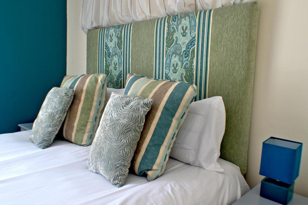 A bed or beds in a room at Rooms at Uphill 