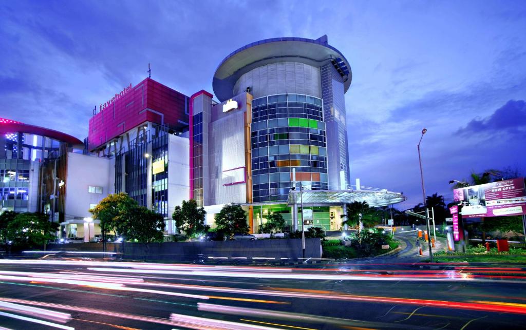 a tall building with a street in front of it at favehotel Pluit Junction in Jakarta