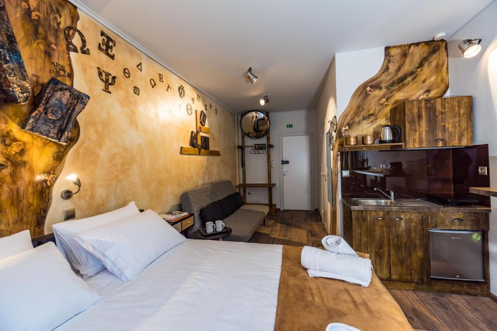 a bedroom with a bed and a living room at GraffitiSuites#Bronze in Thessaloniki