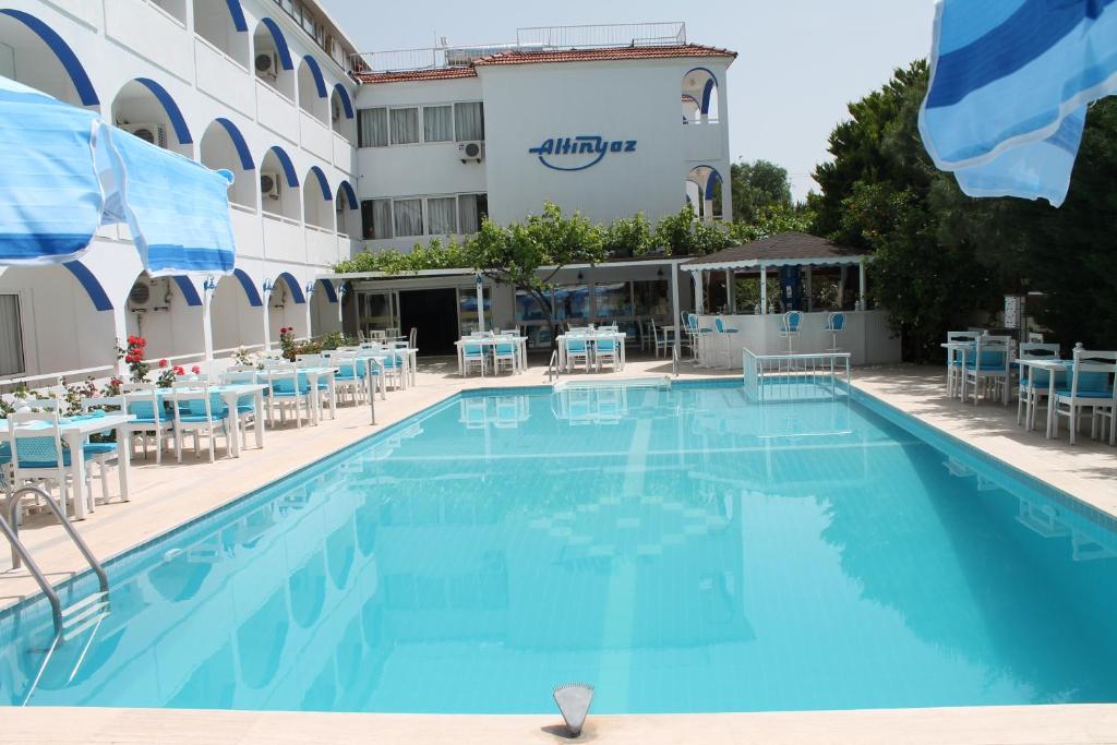 a large swimming pool in front of a hotel at Altinyaz Hotel in Çeşme