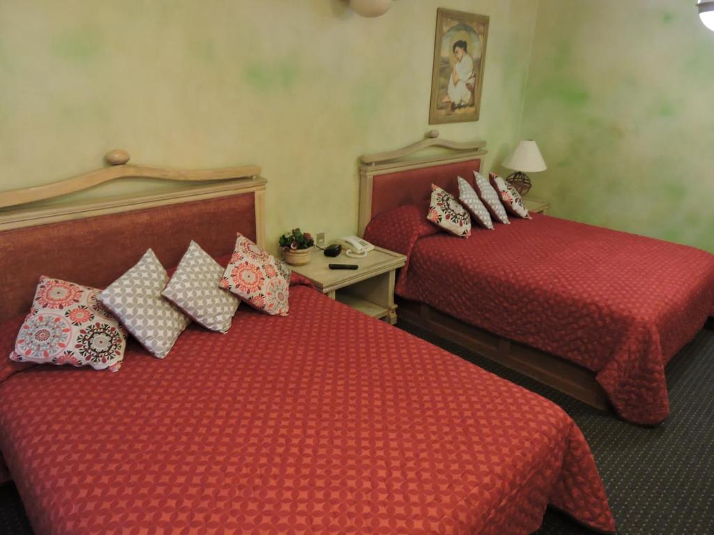 Postel nebo postele na pokoji v ubytování Hotel Quinta Cesar