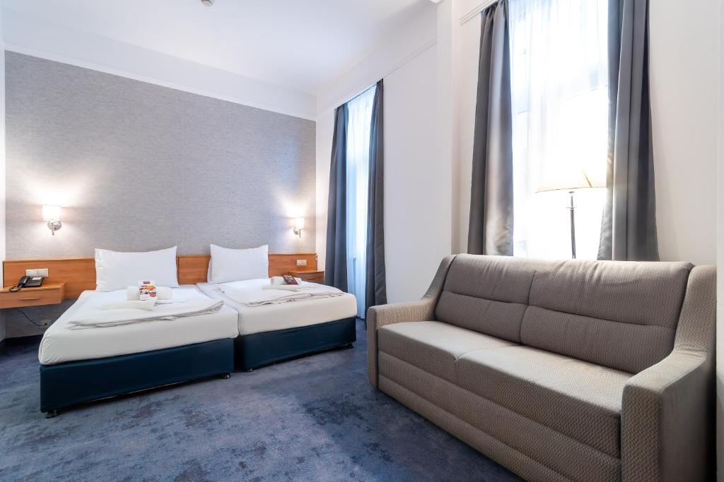 Postel nebo postele na pokoji v ubytování East City Budapest