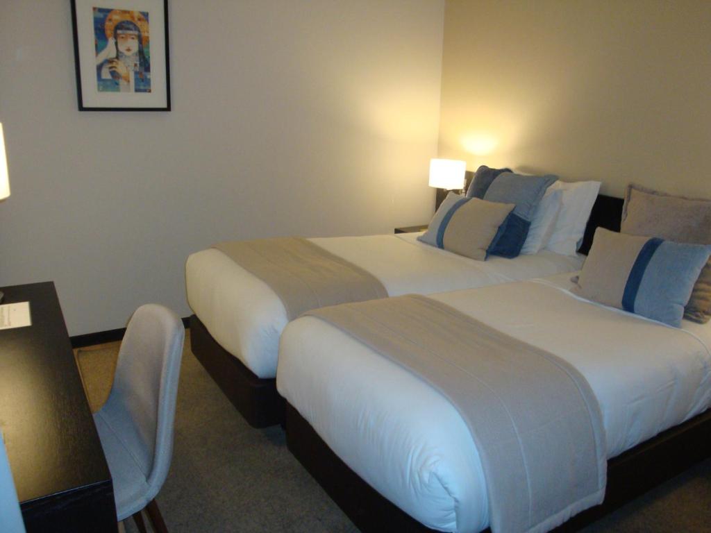 Postel nebo postele na pokoji v ubytování TURIM Aveiro Palace Hotel