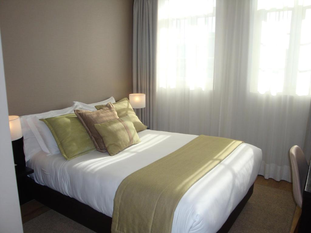 Postel nebo postele na pokoji v ubytování TURIM Aveiro Palace Hotel