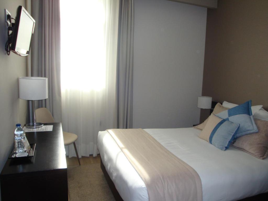 Postel nebo postele na pokoji v ubytování TURIM Aveiro Palace Hotel