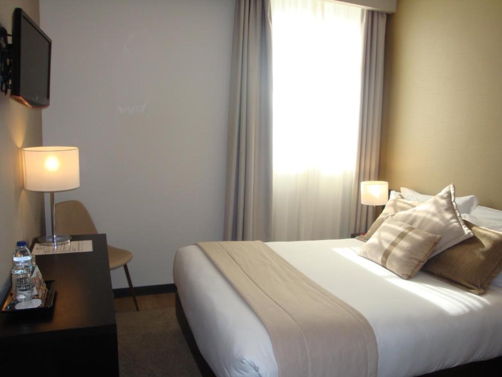 Postel nebo postele na pokoji v ubytování TURIM Aveiro Palace Hotel