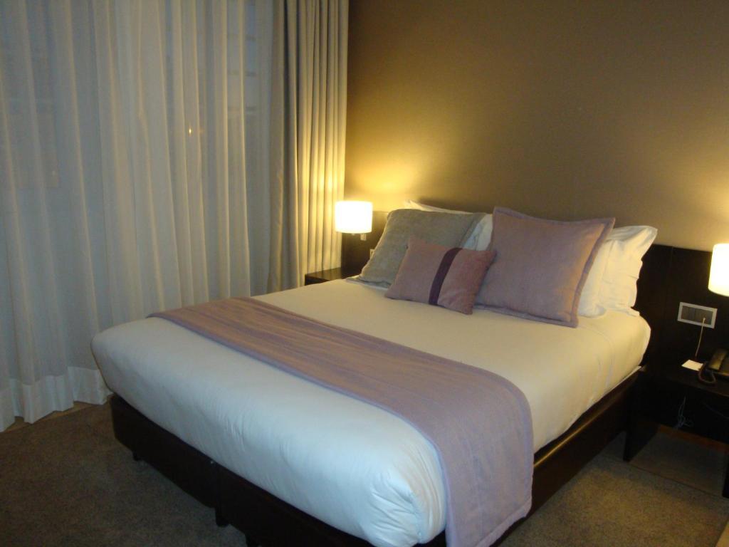 Postel nebo postele na pokoji v ubytování TURIM Aveiro Palace Hotel