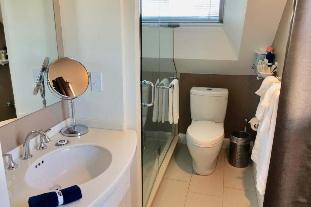 a small bathroom with a sink and a toilet at Benchmark Inn in Provincetown