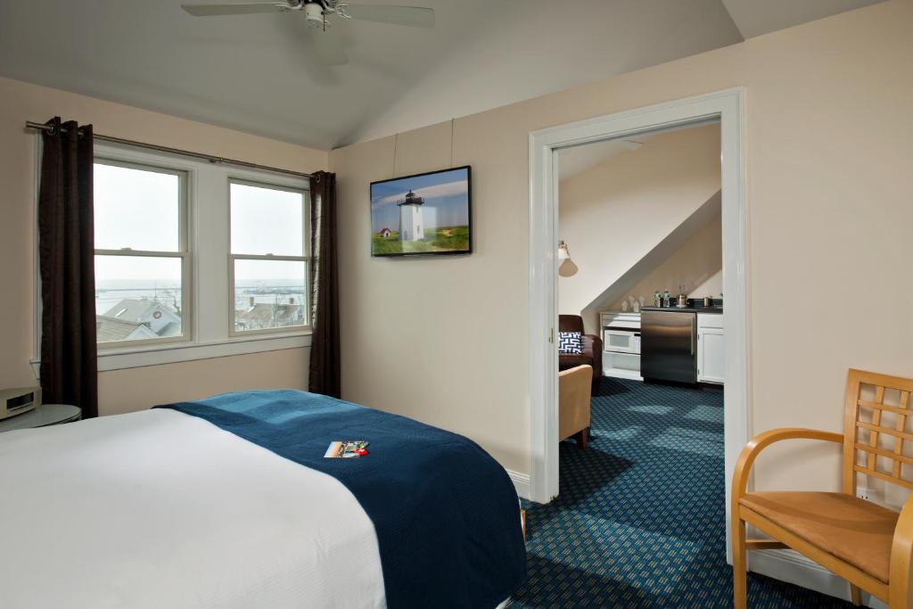 a hotel room with a bed and a window at Benchmark Inn in Provincetown