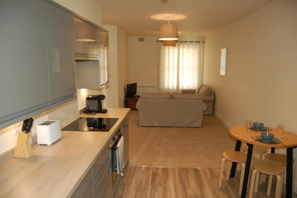 a kitchen and living room with a table and a couch at 3 Endless Street in Salisbury
