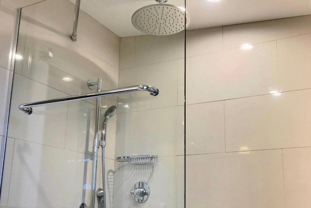 a bathroom with a shower with a glass door at Benchmark Inn in Provincetown