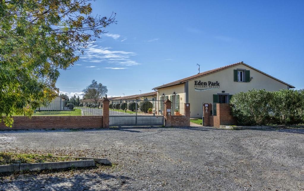 a building with a fence in front of it at Eden Park Resort in Pisa