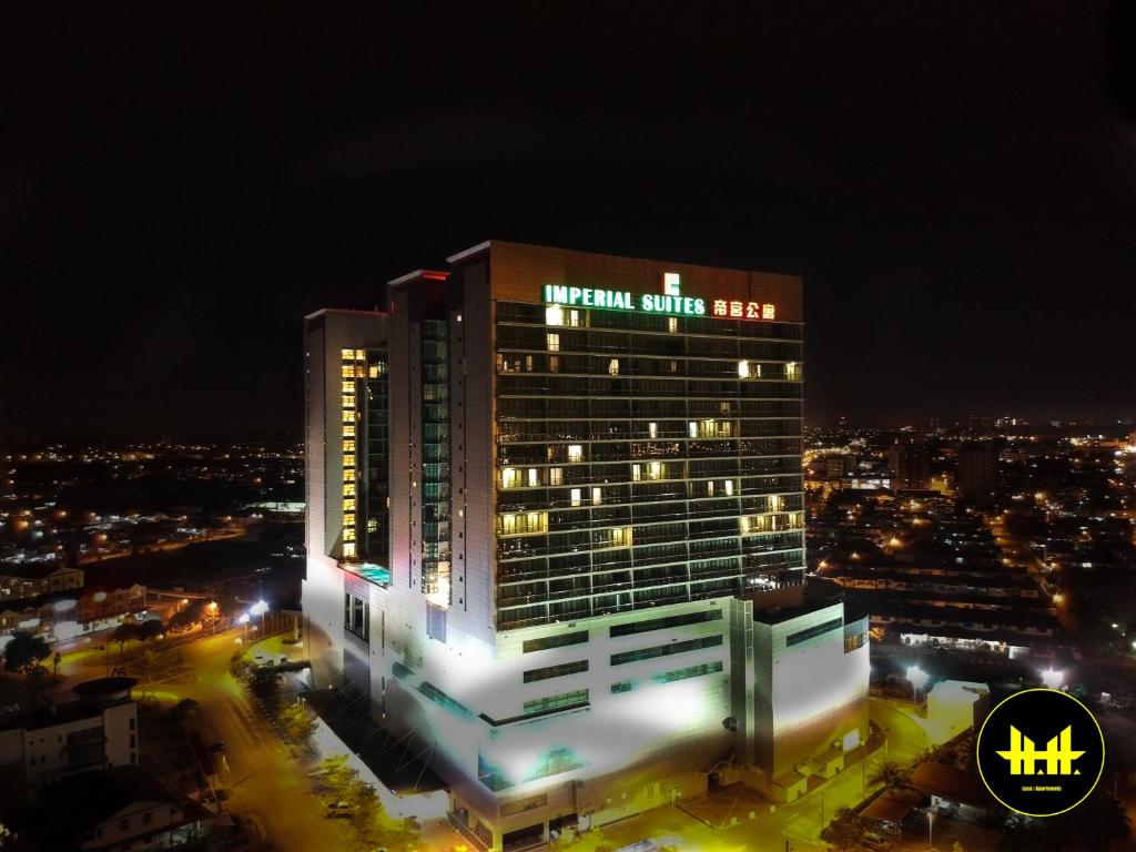 a lit up building with a night view of a city at Luco Apartments @ Imperial Suites Kuching in Kuching