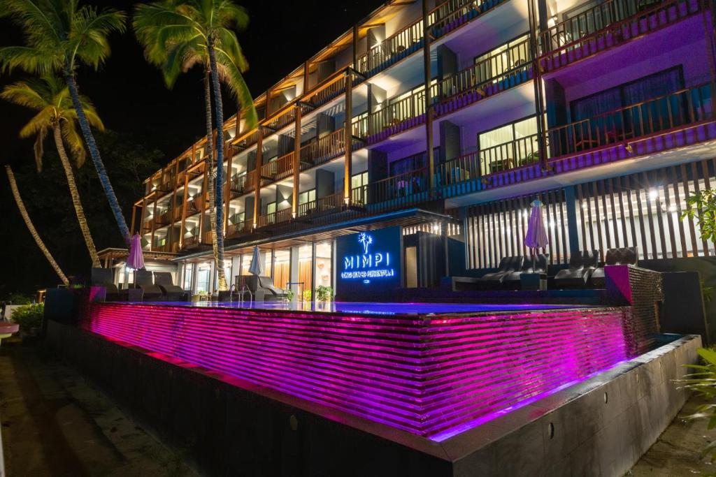 a building with purple lights on the side of it at Mimpi Perhentian in Perhentian Island