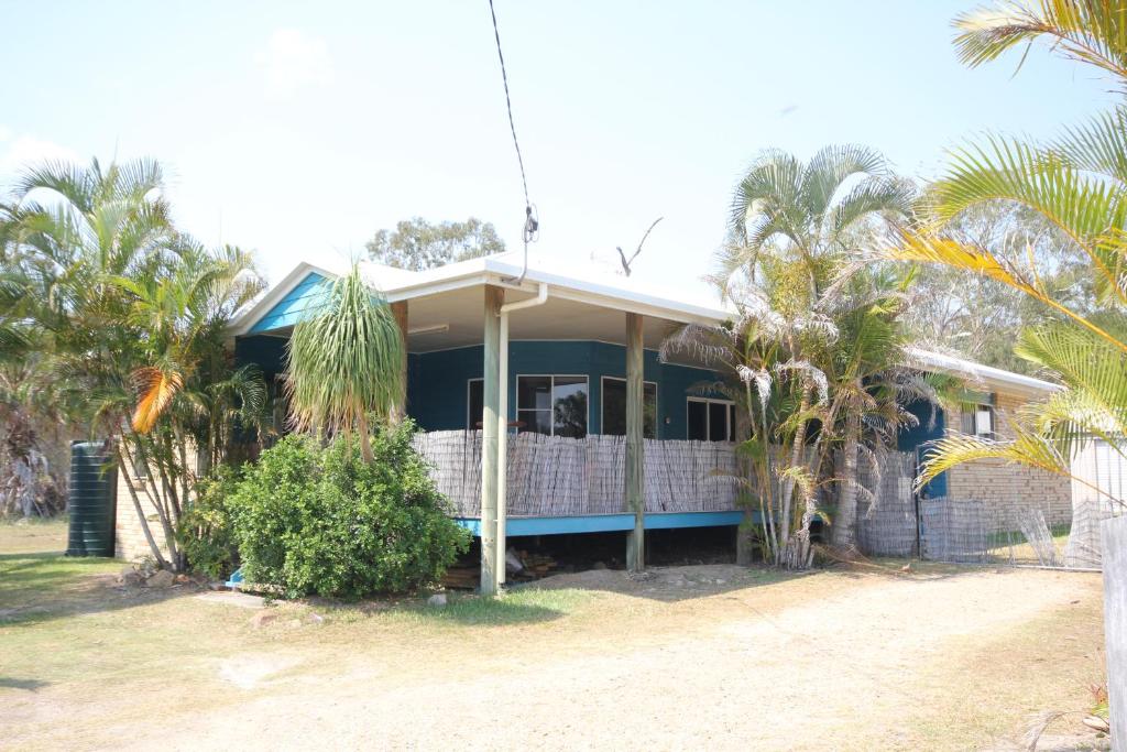 a house with palm trees in front of it at CASTAWAY BEACH HOUSE- NO Parties - NO Pets in Agnes Water