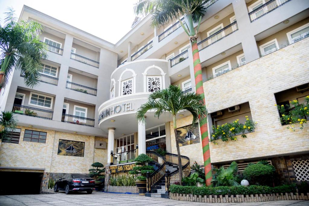 ein Gebäude mit Palmen davor in der Unterkunft Ha Trinh Hotel in Biên Hòa