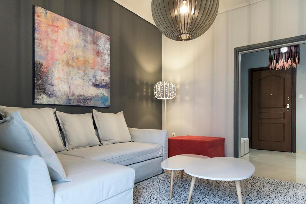 a living room with a white couch and a table at Penelope's Luxury Apartment in Athens