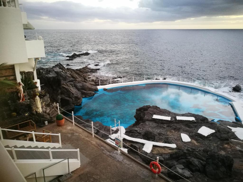 a swimming pool on the edge of the ocean at Aquarius Loft in Callao Salvaje