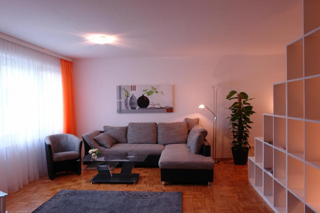 a living room with a couch and a chair at Pension Zeitlos in Potsdam