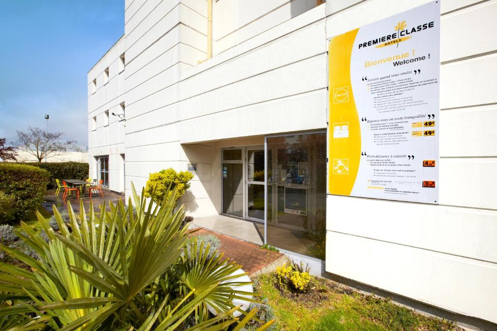 a sign on the side of a building at Premiere Classe Bordeaux Nord - Lac in Bordeaux