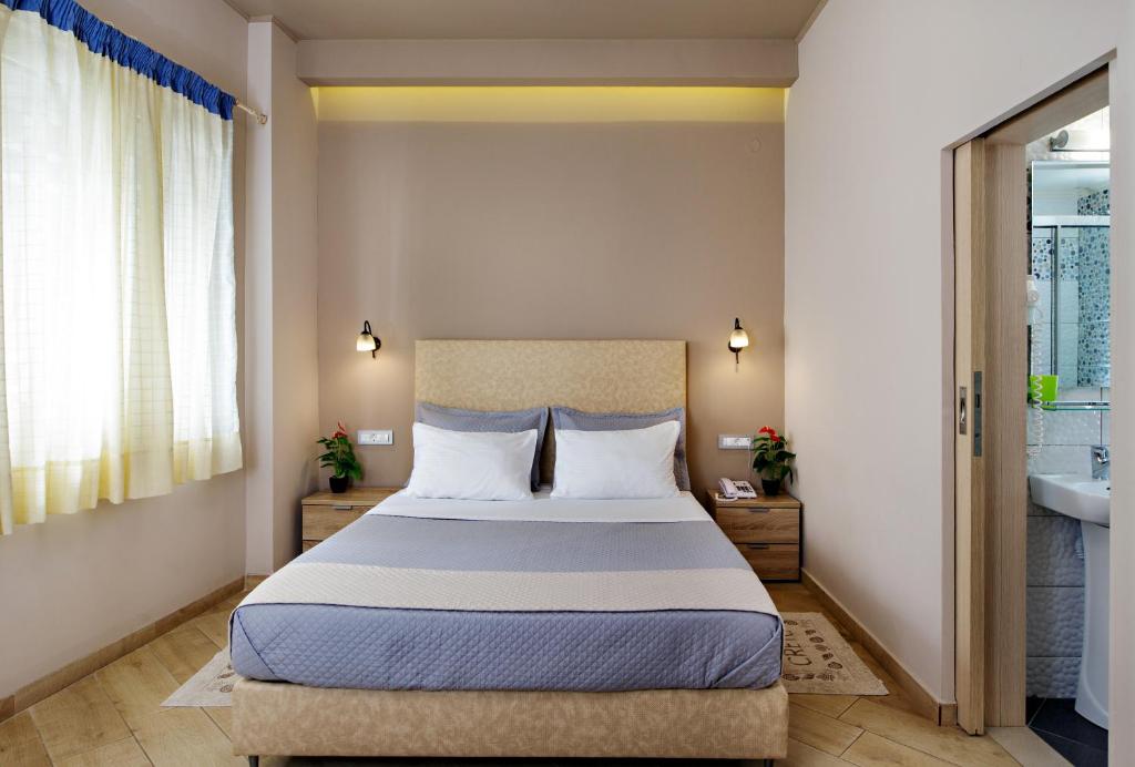 Postel nebo postele na pokoji v ubytování Hotel Ideon