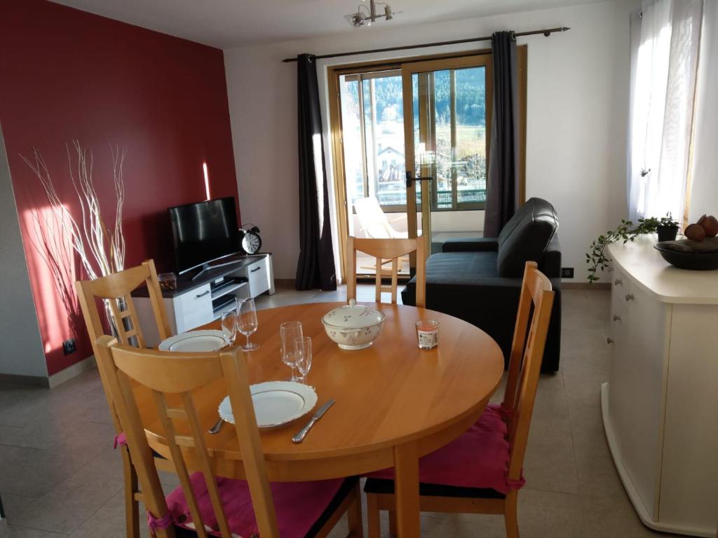 a wooden table with chairs and a dining room at Studio de vacances in Travers