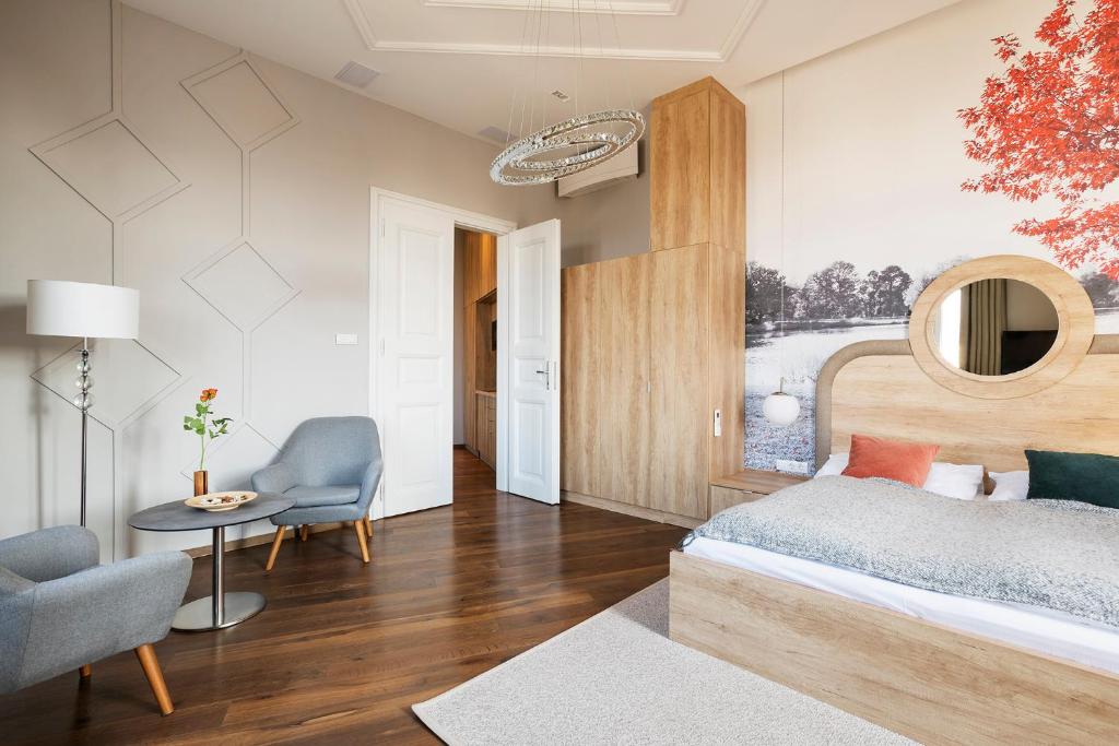 布達佩斯的住宿－Lakeside Budapest Residences，一间卧室配有一张床、一把椅子和一张桌子
