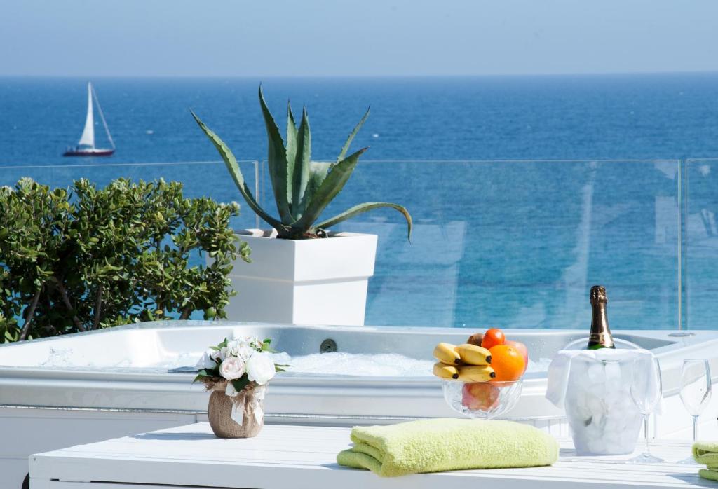a bath tub with fruit on a table with a view of the ocean at Bellariva Monopoli B&B e Relax in Monopoli