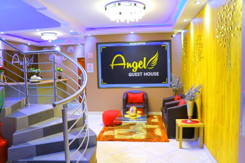 a living room with a spiral staircase and a tv at Angel Guest House in Johannesburg