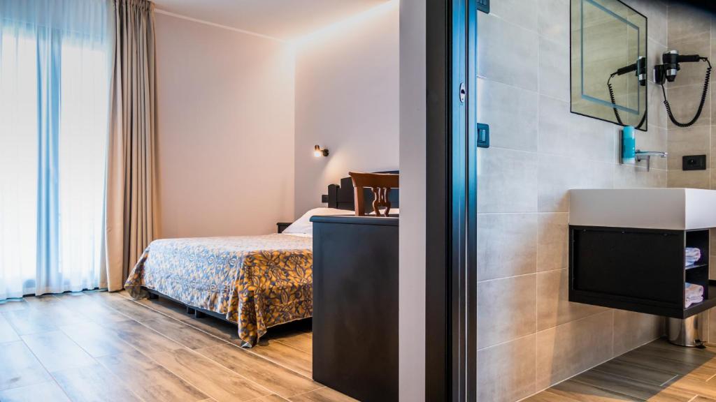 Postel nebo postele na pokoji v ubytování Hotel Smeraldo