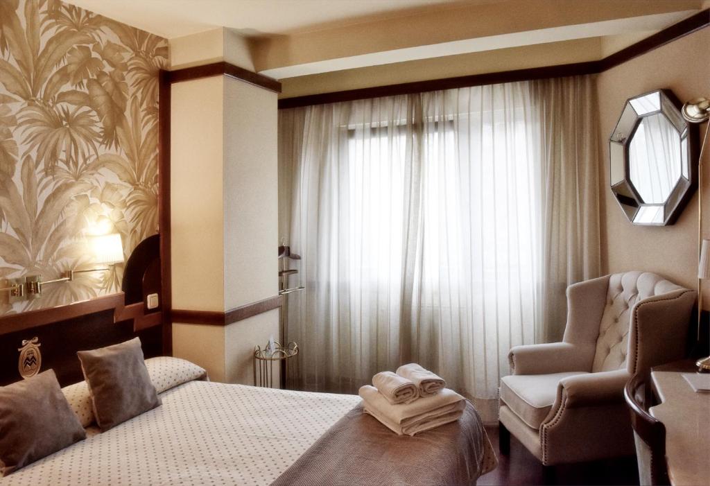 Postel nebo postele na pokoji v ubytování Hotel Maria Luisa