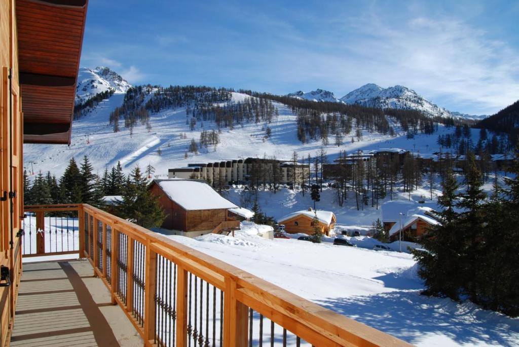 a balcony with a view of a snow covered mountain at grand chalet plein sud in Montgenèvre