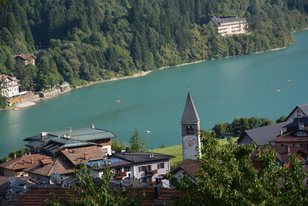 a town with a clock tower next to a lake at Casa Angelo in Molveno