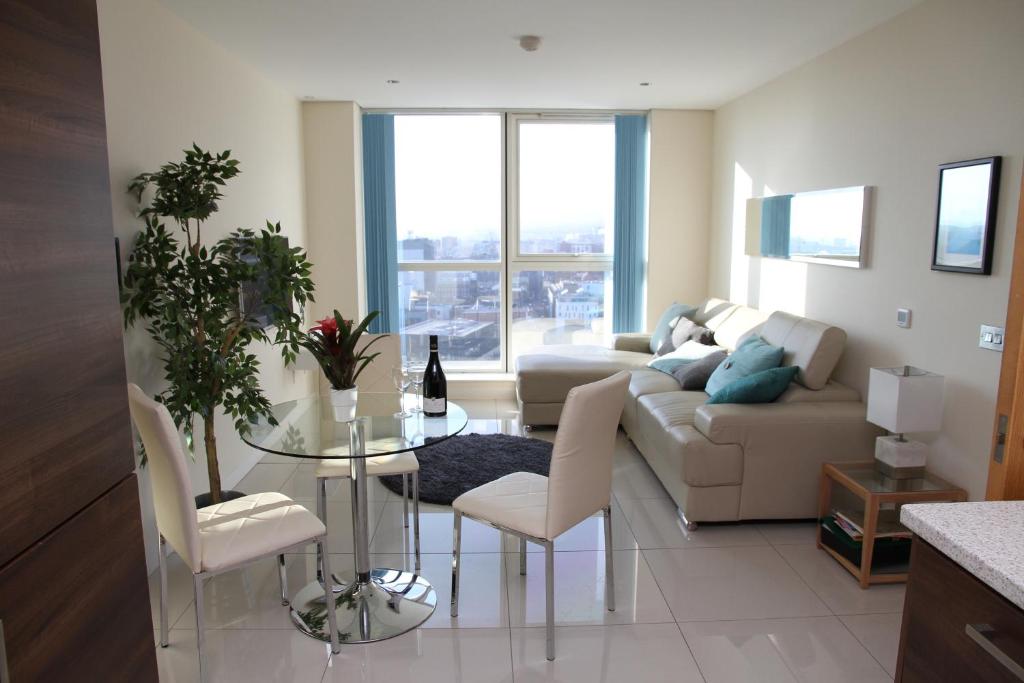 a living room with a couch and a table at City Centre Apartments in Belfast