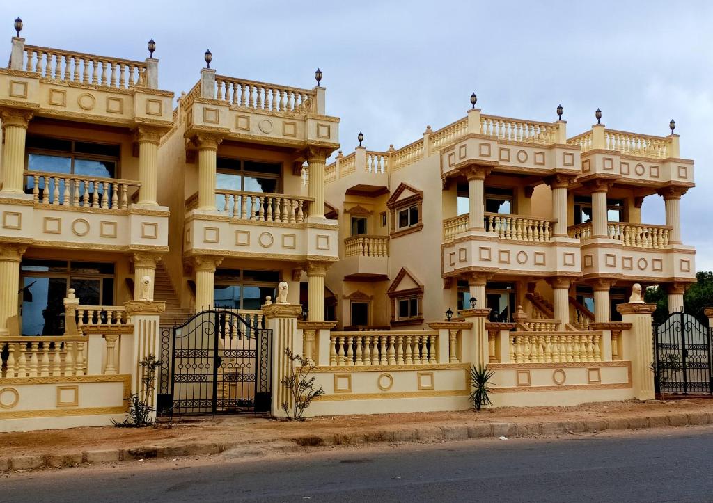 a large yellow building with balconies on it at lucky house Dahab in Dahab