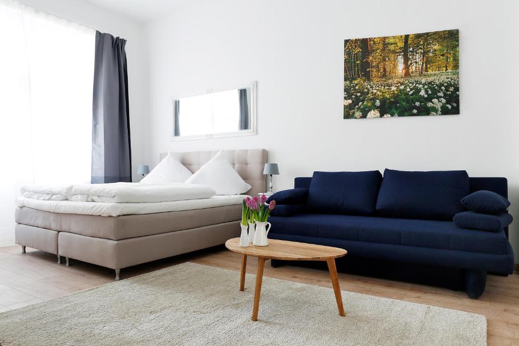 a living room with a couch and a table at Apartment BLISSE Large & Cozy Family & Business Flair welcomes you - Rockchair Apartments in Berlin