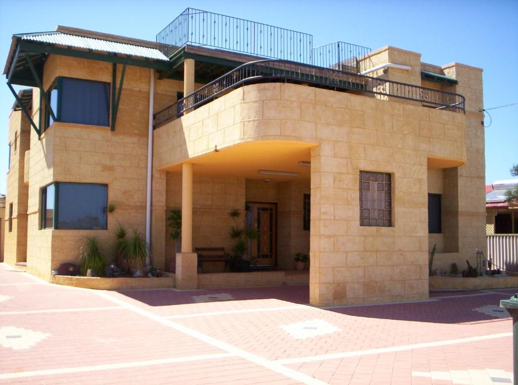 a brick building with a balcony on top of it at Shark Bay Views B & B in Denham