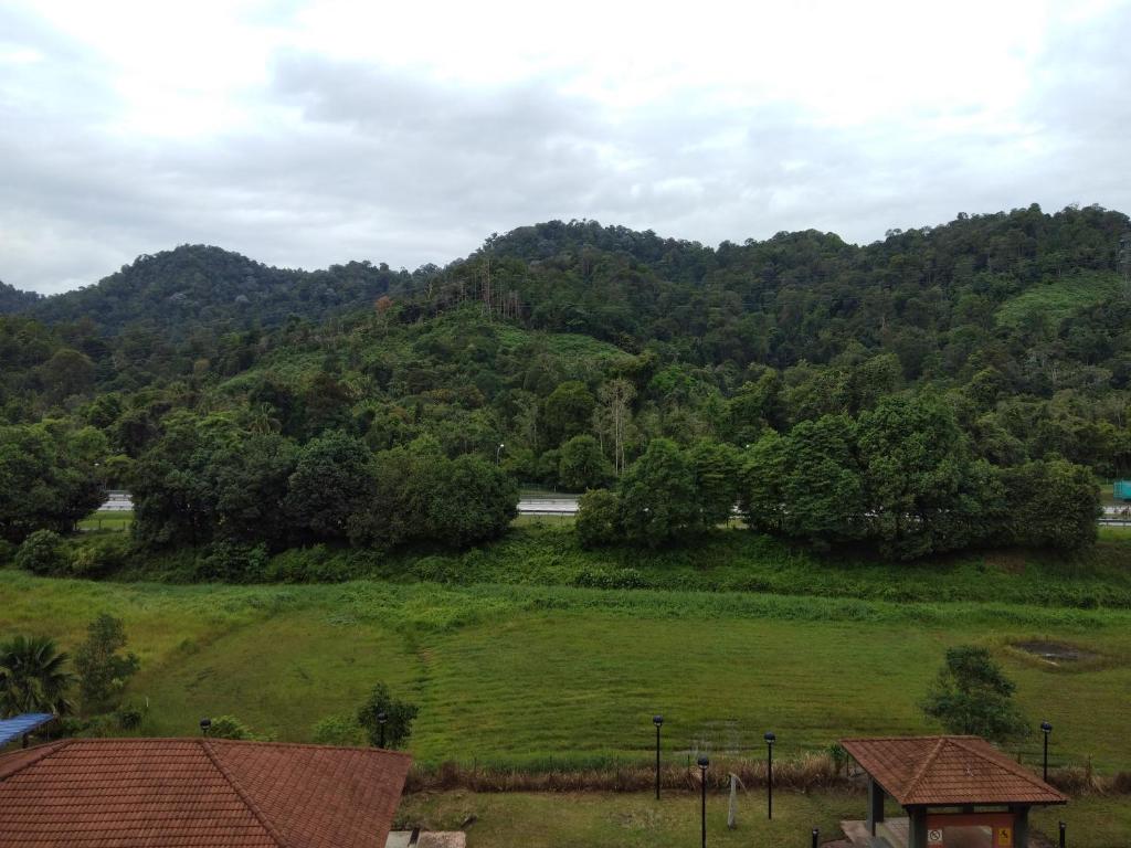 a hillside with a green field and trees at Bukit Merah 99 Motel(Suria Apartment) in Kampong Selemat