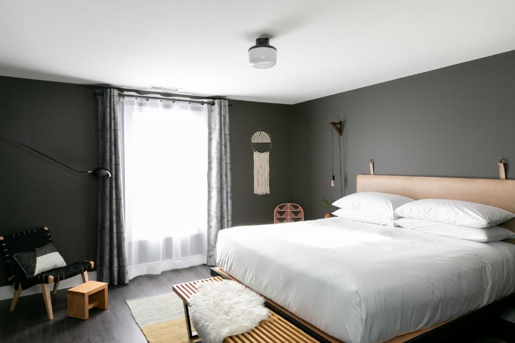 a bedroom with a large white bed and a window at Bode Nashville in Nashville