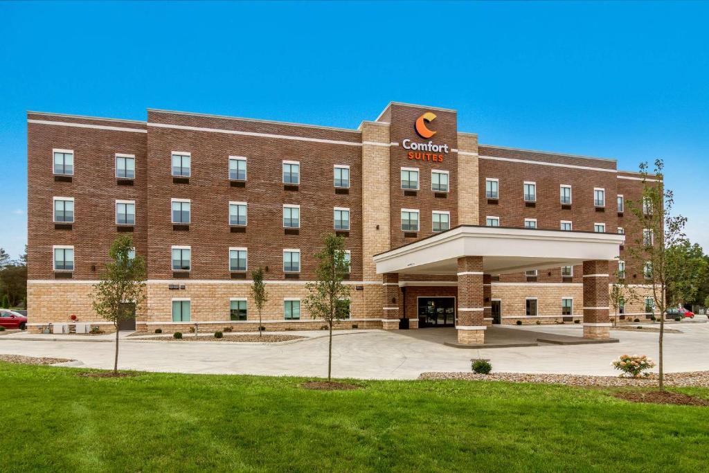 a large red brick building with a cincinnati campus at Comfort Suites in Wooster