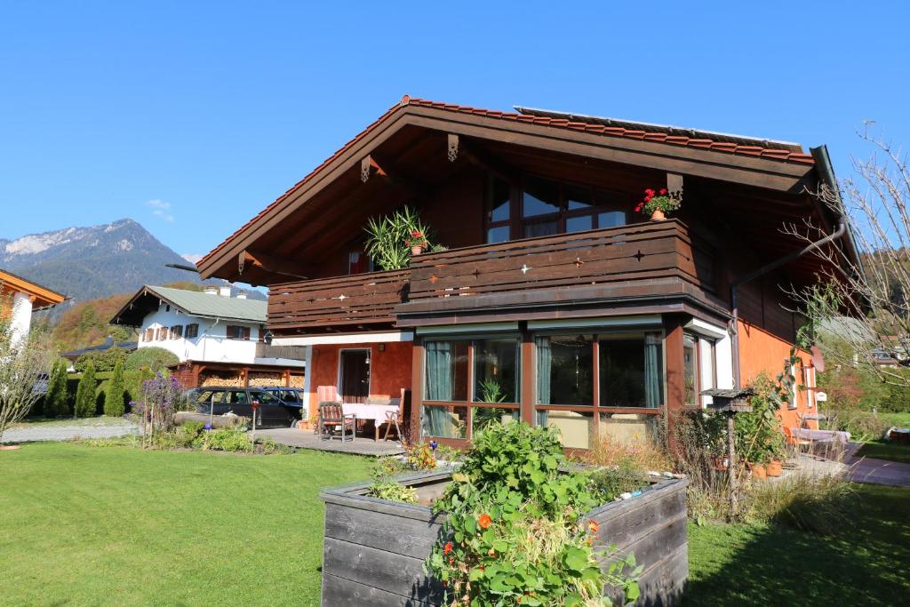 a wooden house with a garden in front of it at Haus Rosenrot in Bischofswiesen