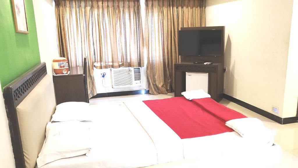 Postel nebo postele na pokoji v ubytování Hotel Rajavihar