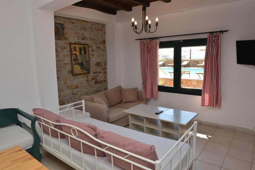 a living room with a couch and a table at Paradisia Villas in Naxos Chora