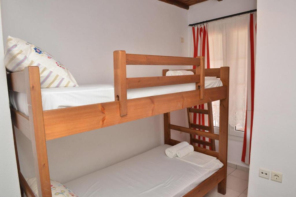 two bunk beds in a room with a window at Paradisia Villas in Naxos Chora