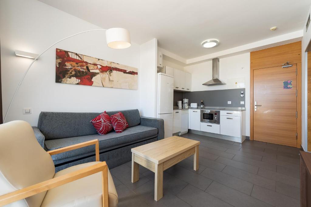 a living room with a couch and a table at Holiday Club Puerto Calma in Puerto Rico de Gran Canaria